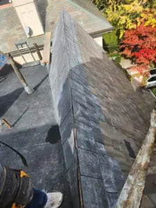 Completed courses of natural Slate tiles running up a Dormer sloped Roof with a closed Slate Ridge ready for copper Ridge Cap installation on a Rosedale Toronto heritage home by Right Choice Roofing and Repair