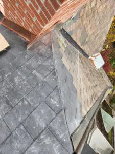 Completed partial natural Slate Roof replacement on a Rosedale Toronto heritage home with the existing aged copper Valley preserved in place between the slopes by Right Choice Roofing and Repair