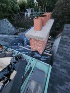 Progress photo showing full slate roofing system replacement mid-demo with Grace Select underlayment installed on main slope and demolition debris staged on flat roof below in Harbord Village Toronto by Right Choice Roofing and Repair