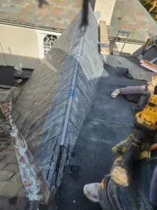 Slate tile repair in progress on a Dormer sloped Roof of a Rosedale Toronto heritage home with completed Slate courses and work staged on the new modified bitumen flat Roof below by Right Choice Roofing and Repair