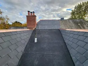 Stunning final image of a completed natural Slate Roof and flat Roof replacement on a Rosedale Toronto heritage home with new copper Valley Flashing, modified bitumen flat Roof, aluminum high dome plumbing flange, and brick Chimney Flashing by Right Choice Roofing and Repair