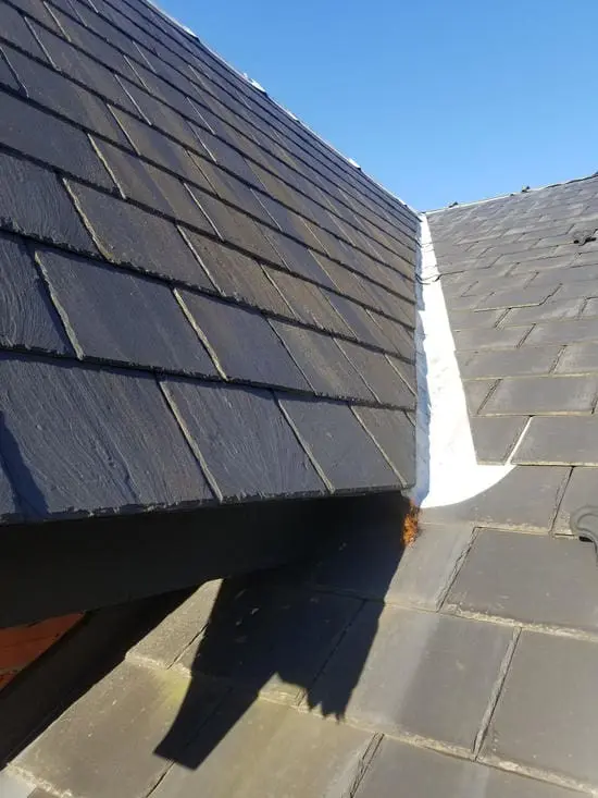 Before photo showing wildlife damaged lead valley flashing between slate roof sections in Harbord Village Toronto prior to copper conversion by Right Choice Roofing and Repair