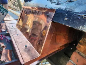 Completed custom fabricated copper wildlife barrier enclosure to prevent squirrel infestation in Toronto by Right Choice Roofing and Repair.