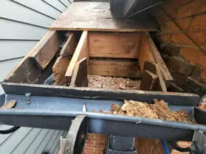 Progress photo showing severely rotted rafters and roof deck sheathing exposed on main sloped roof during slate replacement in Harbord Village Toronto by Right Choice Roofing and Repair