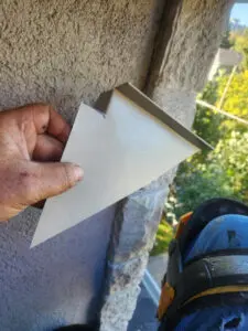 Custom metal flashing piece fitted during a multi-layer Soffit repair in Toronto