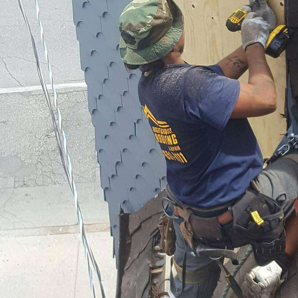 roofer working on side of building